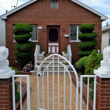 nice brick house with a white gate in front of it